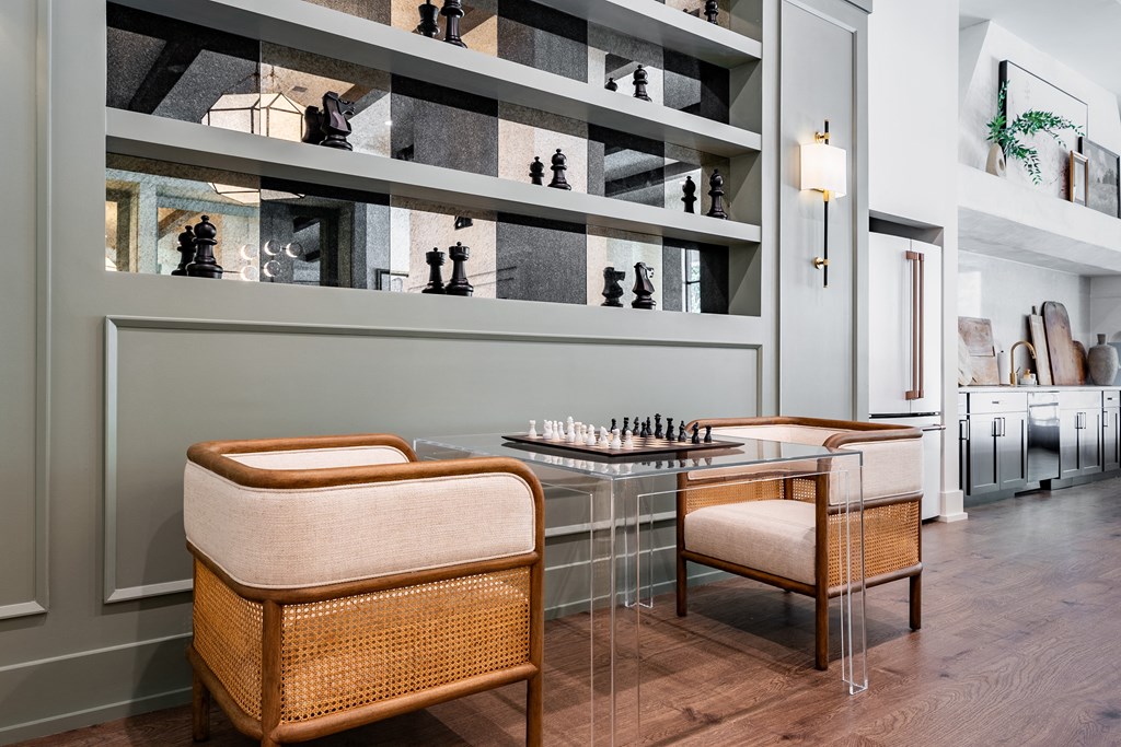 Amenities a dining room with two chairs and a table with a chess board