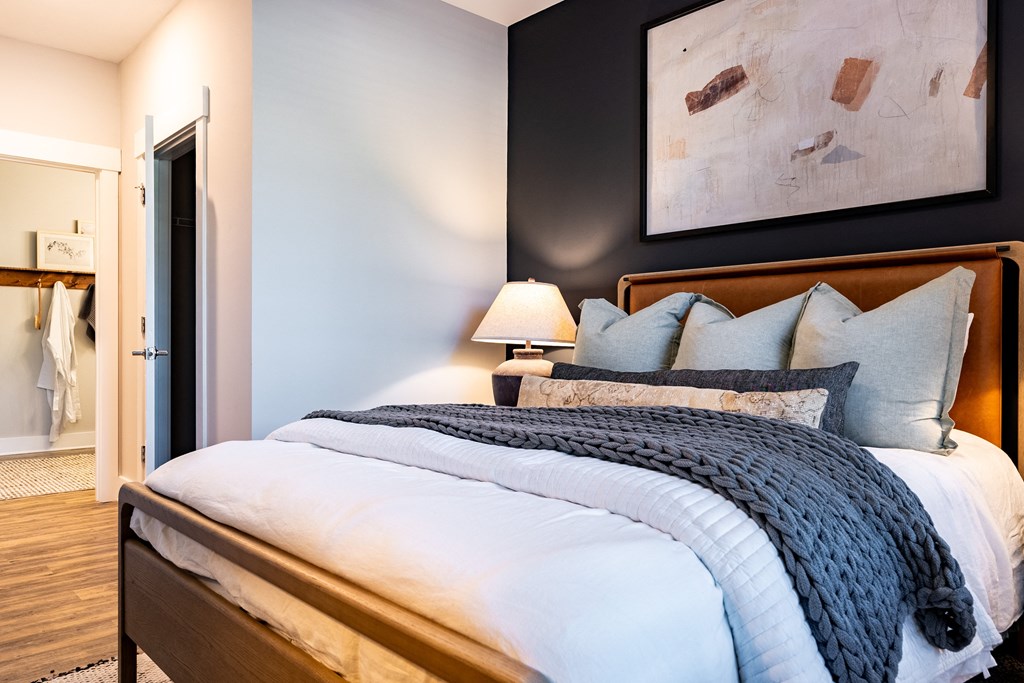 Home Interior a bedroom with a large bed and a painting on the wall