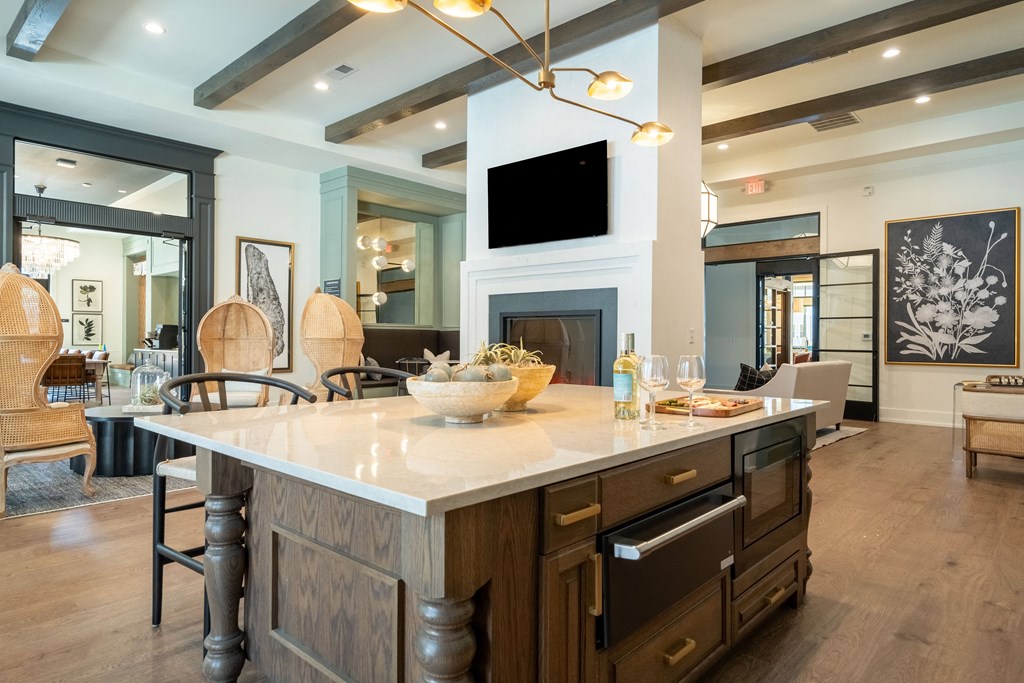 A modern kitchen with a large island and a fireplace.