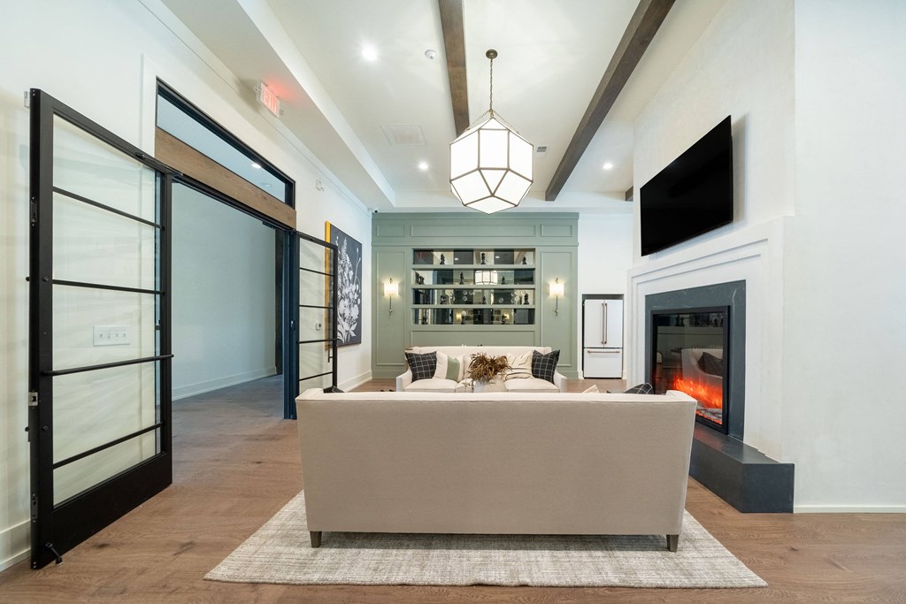 A modern living room with a fireplace and a large couch.