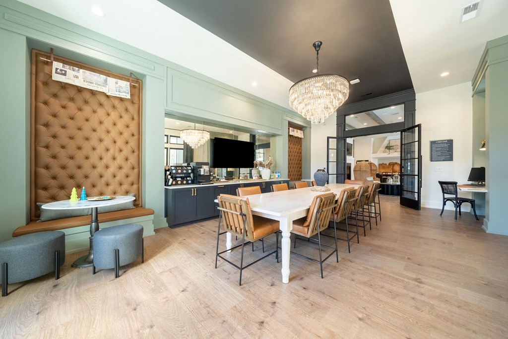 a dining room with a long table and chairs and a bar