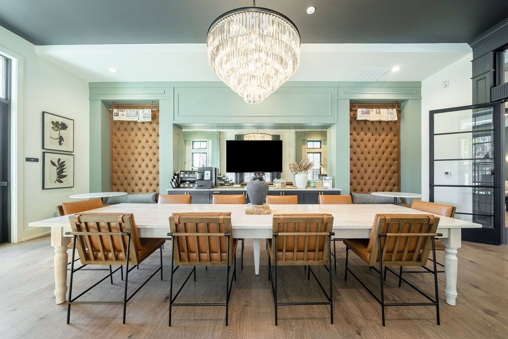 a large dining room with a large table and chairs and a chandelier