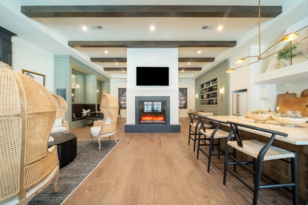 a living room with a fireplace and a table with chairs