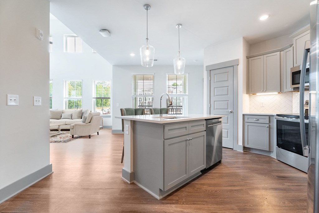 a kitchen with an island and a living room with a couch