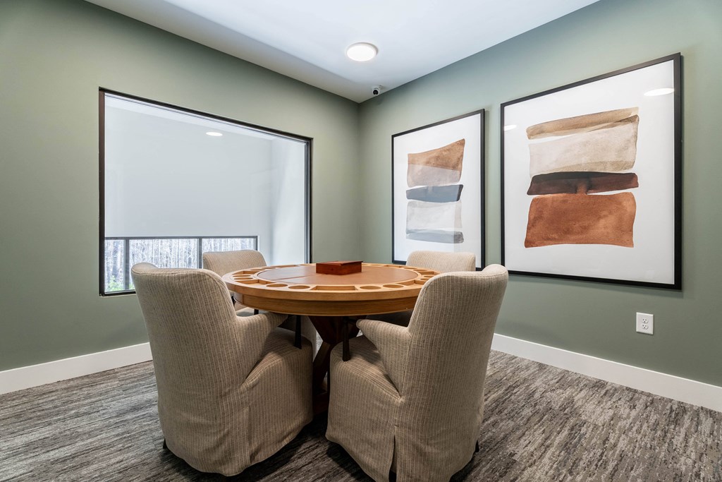 A dining room with a table and chairs.