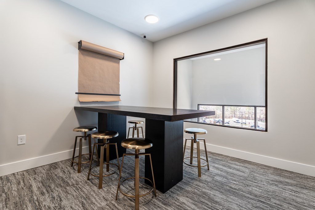 A bar area with a counter and stools.
