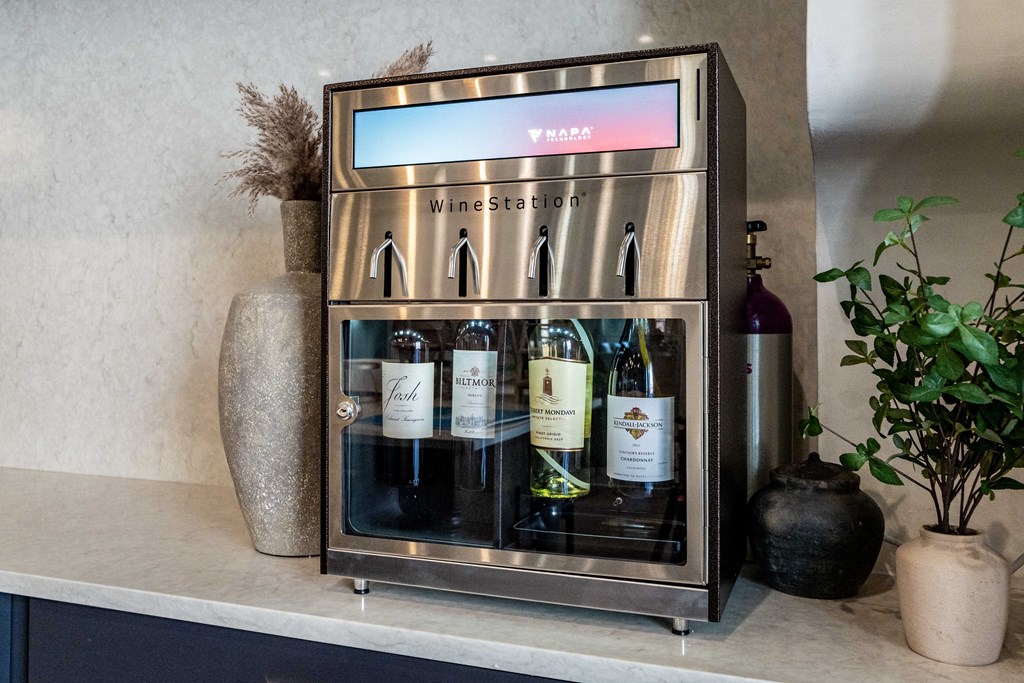 A wine cooler with a digital display and several bottles of wine inside.