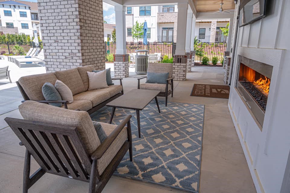 a living room with couches and chairs and a fireplace