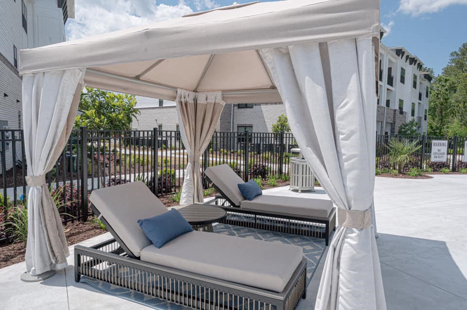 a patio with two couches and a canopy