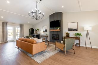 a living room with a fireplace and a tv on the wall