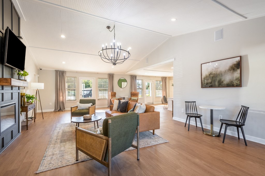 a living room with couches and chairs and a fireplace