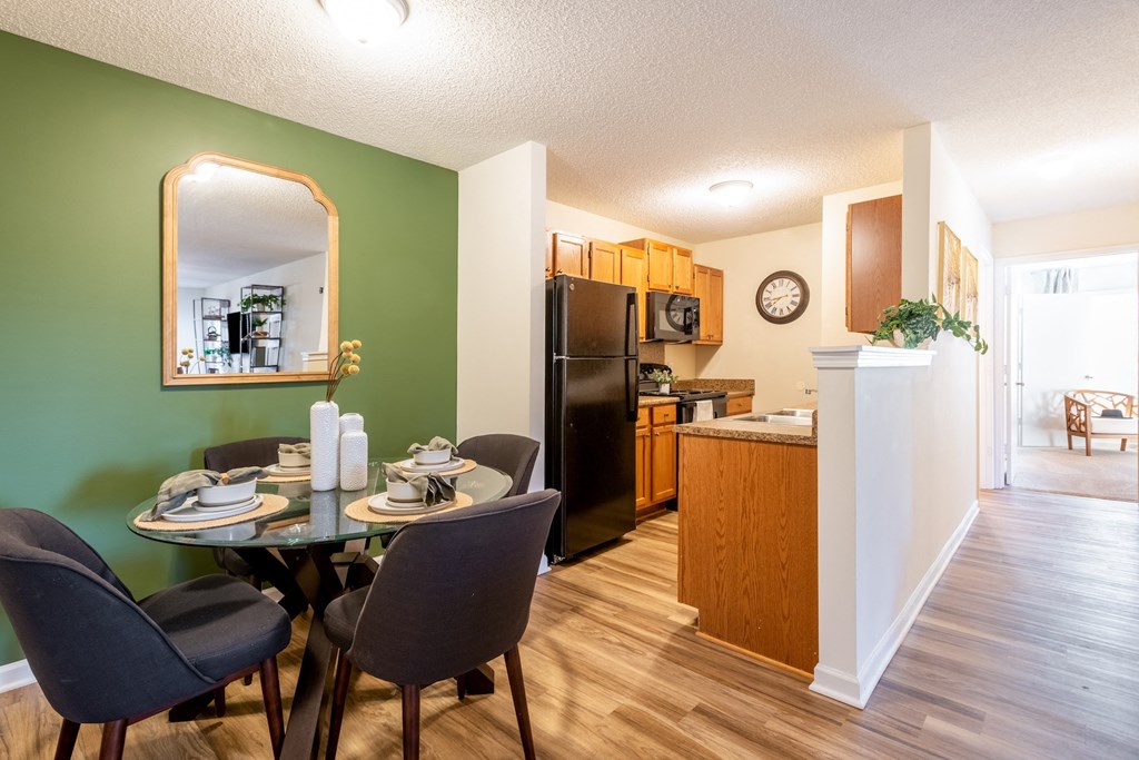 a dining room and kitchen with a table and chairs