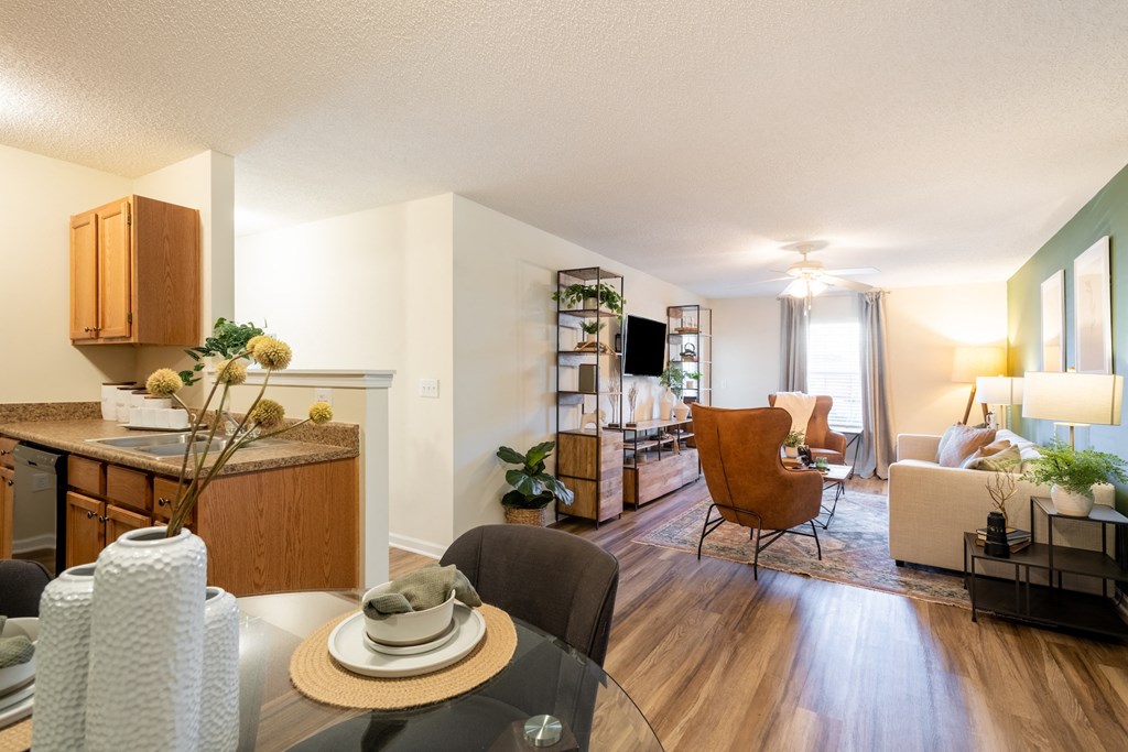 the view of a living room and a dining room with a table and a kitchen