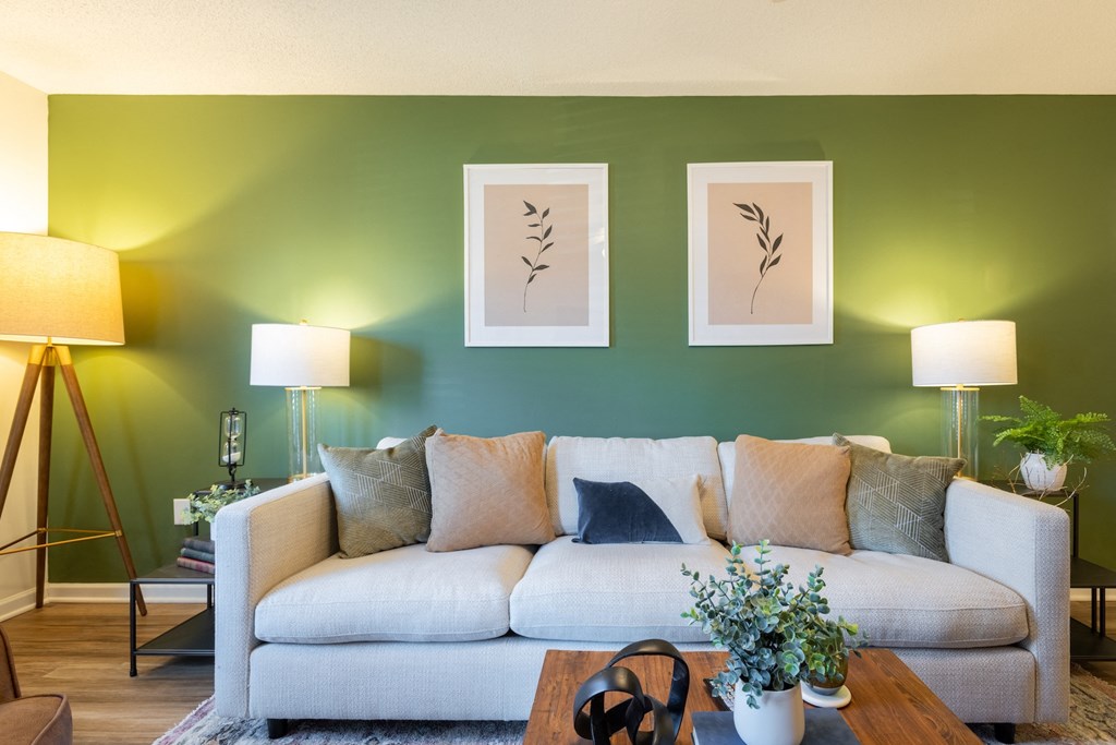 a living room with green walls and a white couch