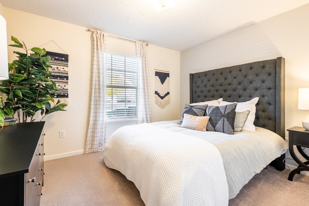 a bedroom with a large bed and a window