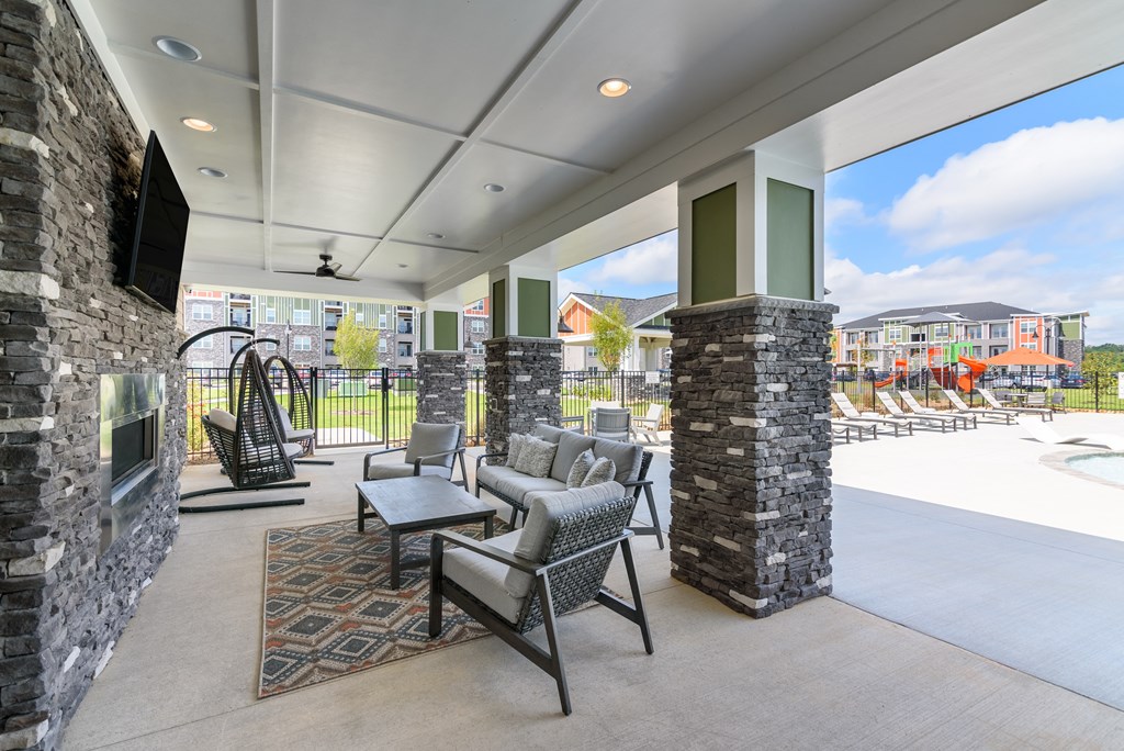the preserve at ballantyne commons resident clubhouse with tables and chairs and a fireplace