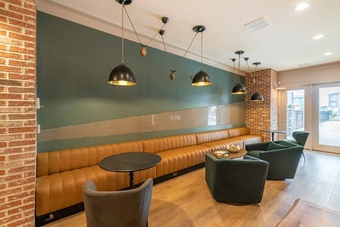 A room with a green wall and a brown couch