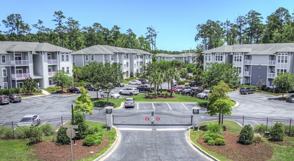 A parking lot in front of apartment buildings.