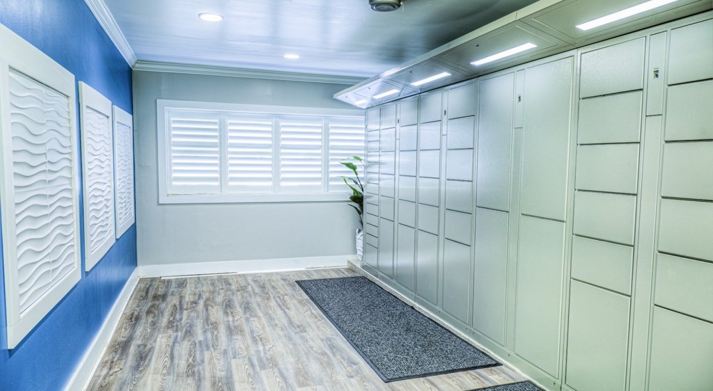 A room with a blue wall and white closet doors.