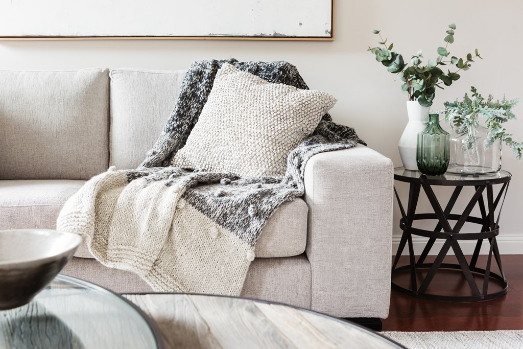 a living room with a couch and a blanket on it