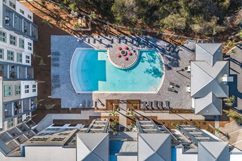 an aerial view of a pool at a hotel with a swimming pool