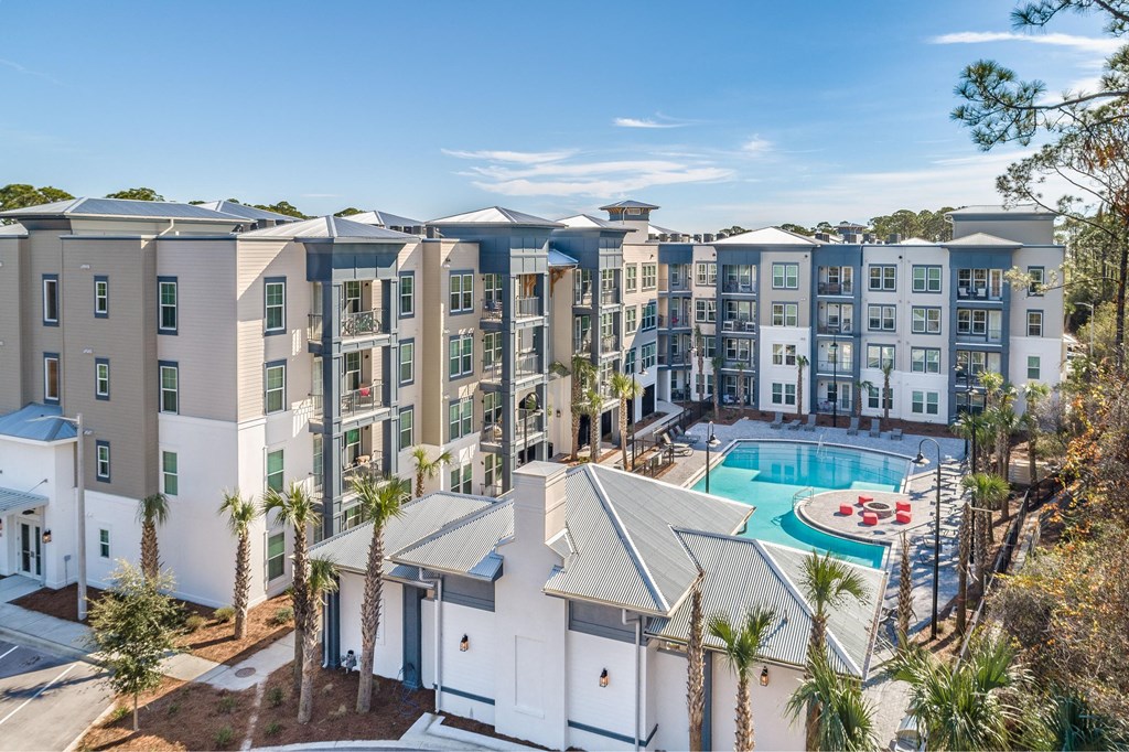 an aerial view of an apartment building with a swimming pool