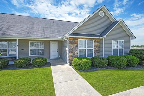 A house with a grey roof and a white door.