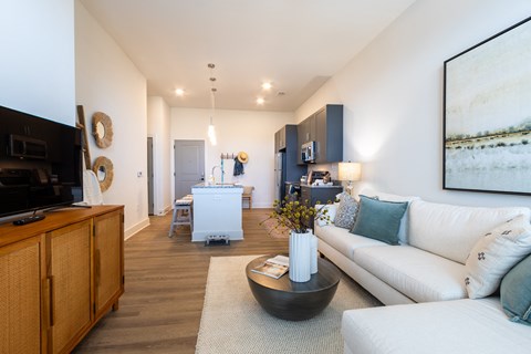 A living room with a white couch and a wooden cabinet.
