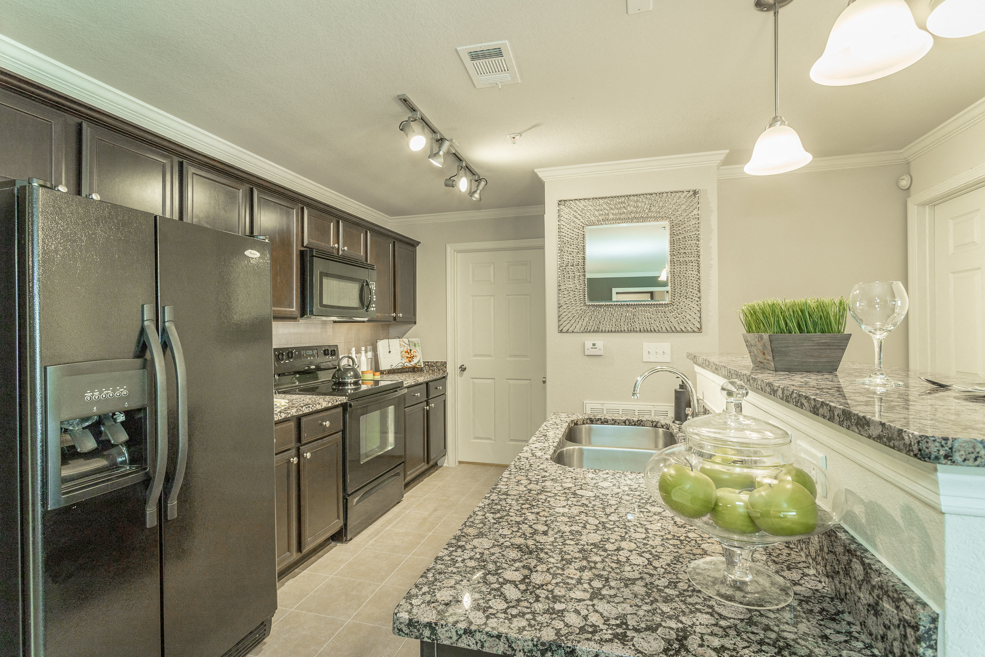Beautiful kitchen with black energy efficient appliances and granite countertops at Amberleigh Ridge