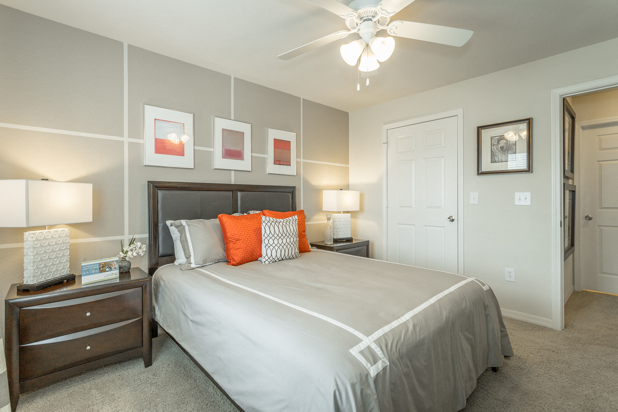 Spacious bedroom with plush carpeting and ceiling fan with lighting