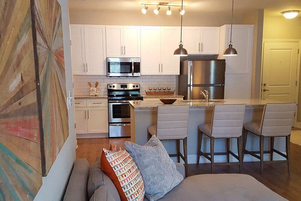 a kitchen with a bar and a living room