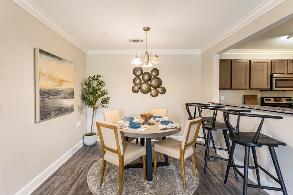a dining room with a table and chairs and a kitchen