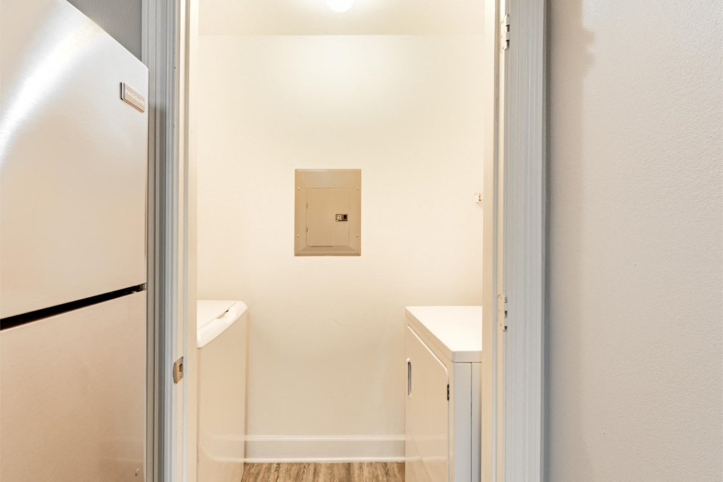 a kitchen with a refrigerator and a sink and a door