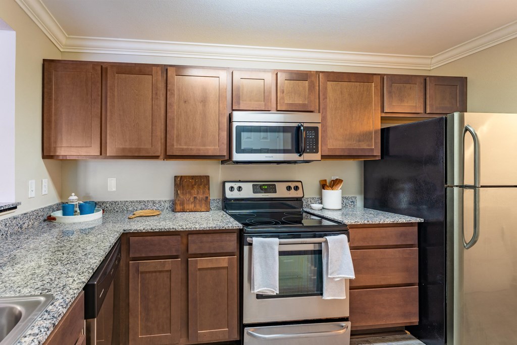 a kitchen with stainless steel appliances and granite counter tops