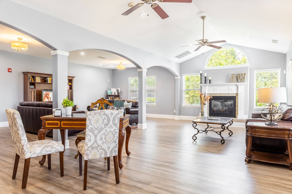 a living room with a table and chairs and a fireplace