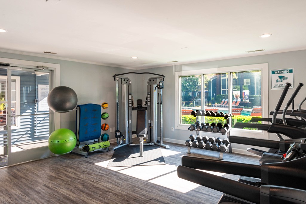 a home gym with a treadmill and weights