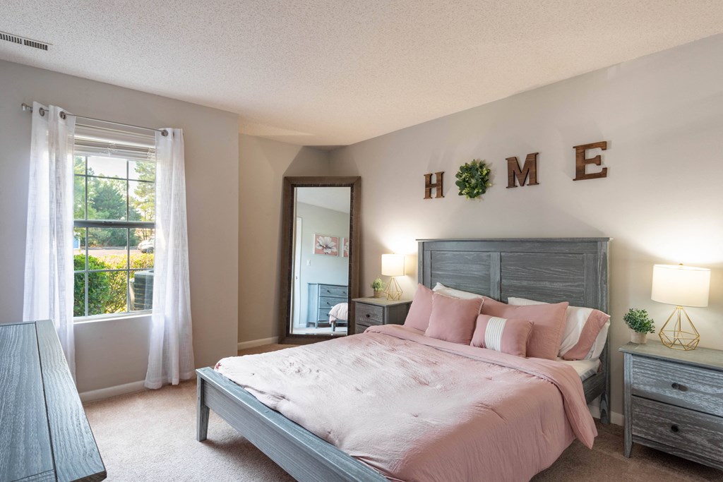 a bedroom with a large bed and a large window