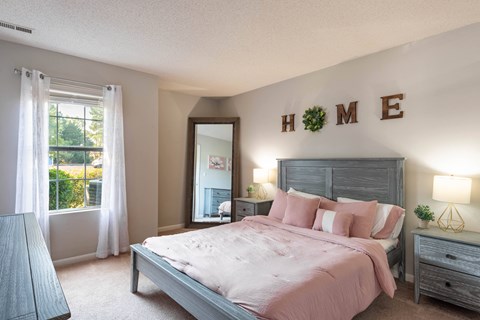 a bedroom with a large bed and a large window