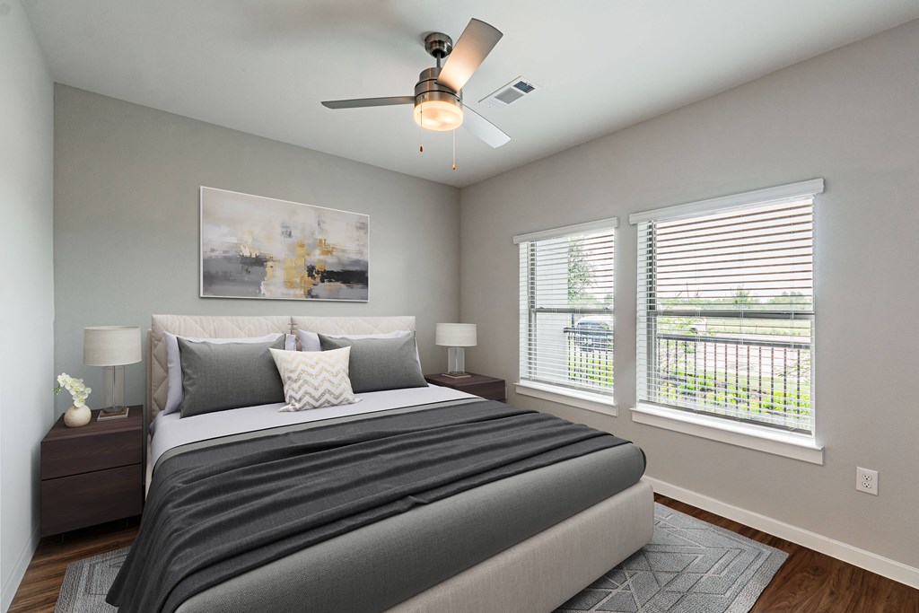 a bedroom with a large bed and a ceiling fan