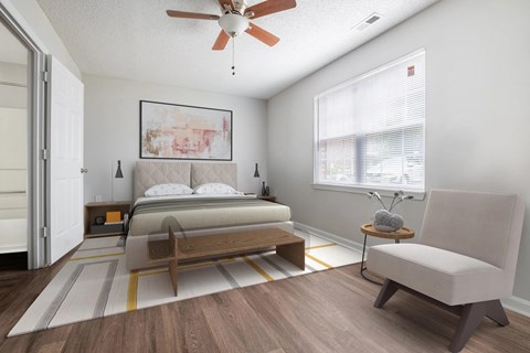 A bedroom with a bed, chair, and a ceiling fan.