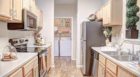 A kitchen with wooden cabinets and a white countertop.