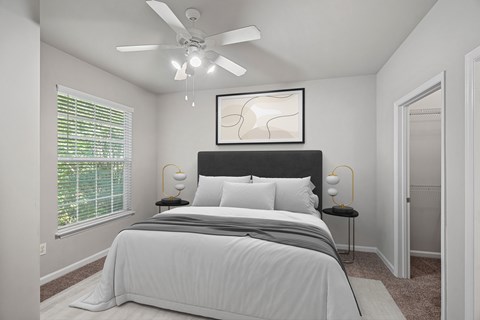 A bedroom with a large bed and a ceiling fan at Hawthorne Bridford in Greensboro, NC.