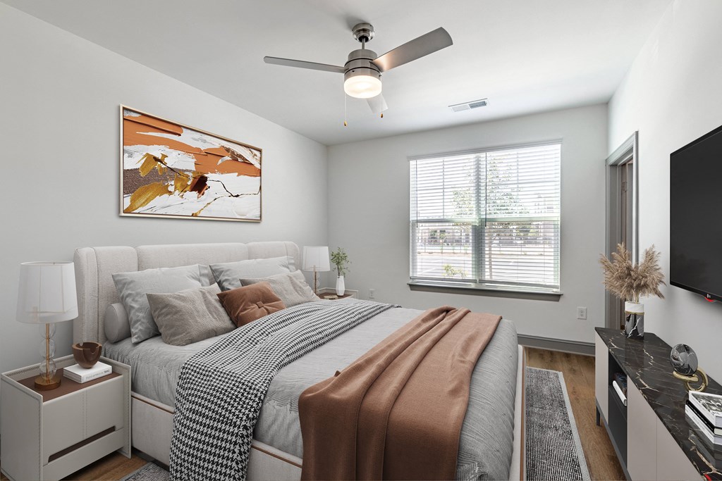 a bedroom with a large bed and a ceiling fan