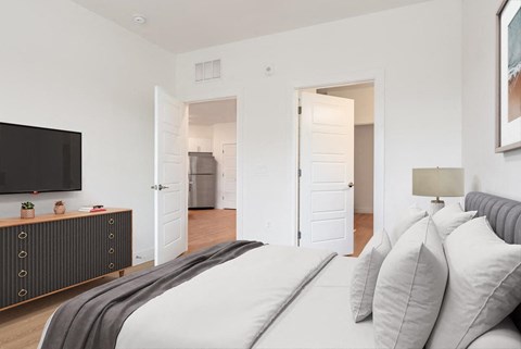 a bedroom with a bed and a tv