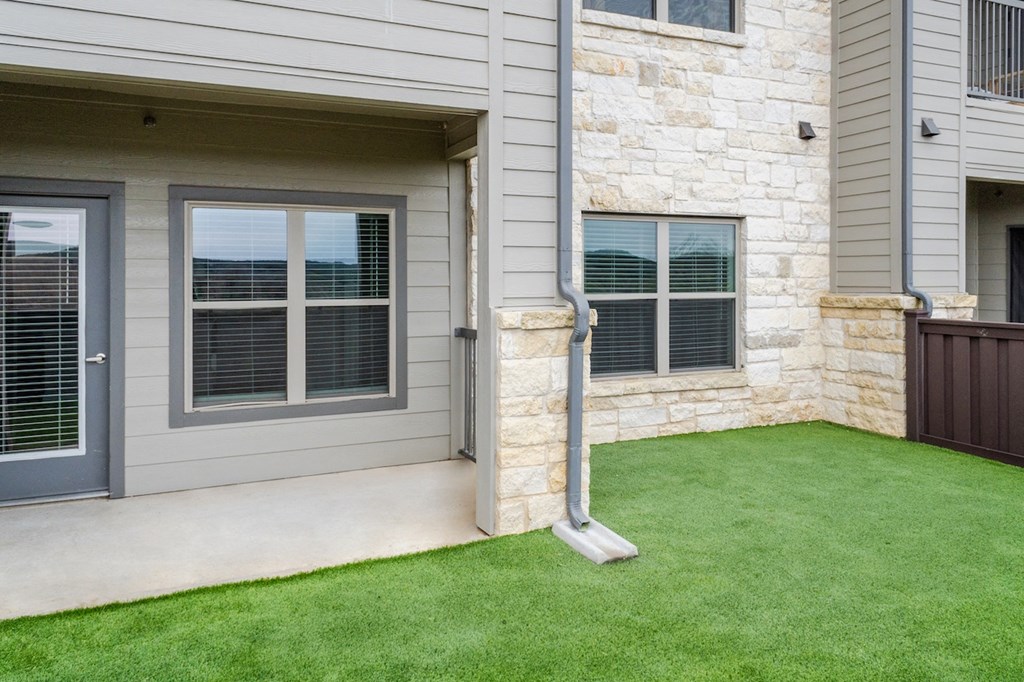 a front porch of a house with a green lawn