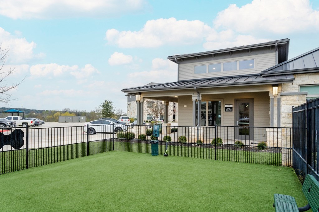 the front yard of a house with a yard and a fence