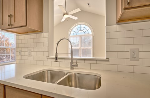 A kitchen with a sink and a window.