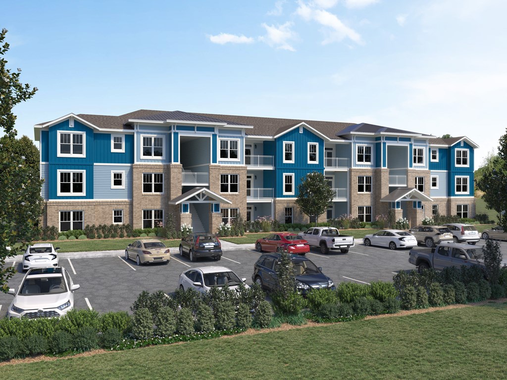 an aerial view of an apartment building with a parking lot