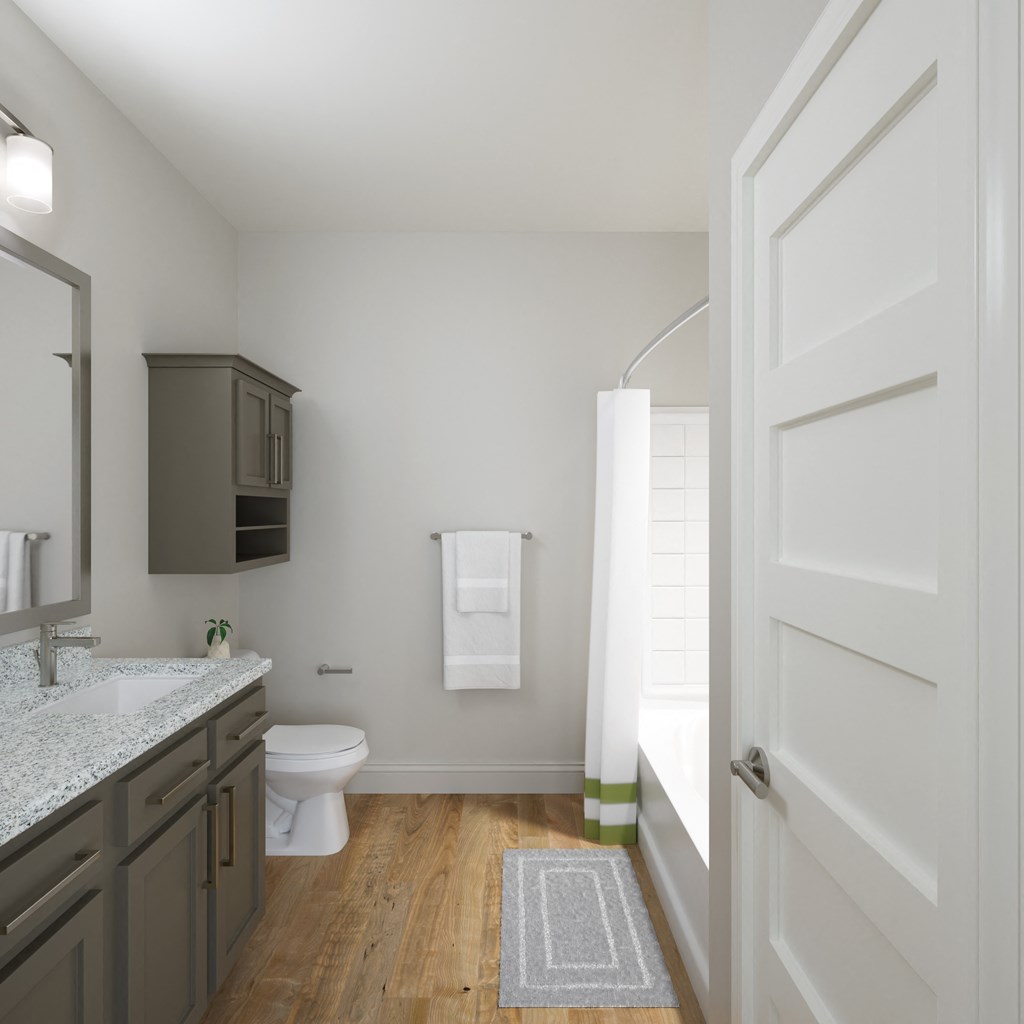 a bathroom with a toilet and a shower and a sink