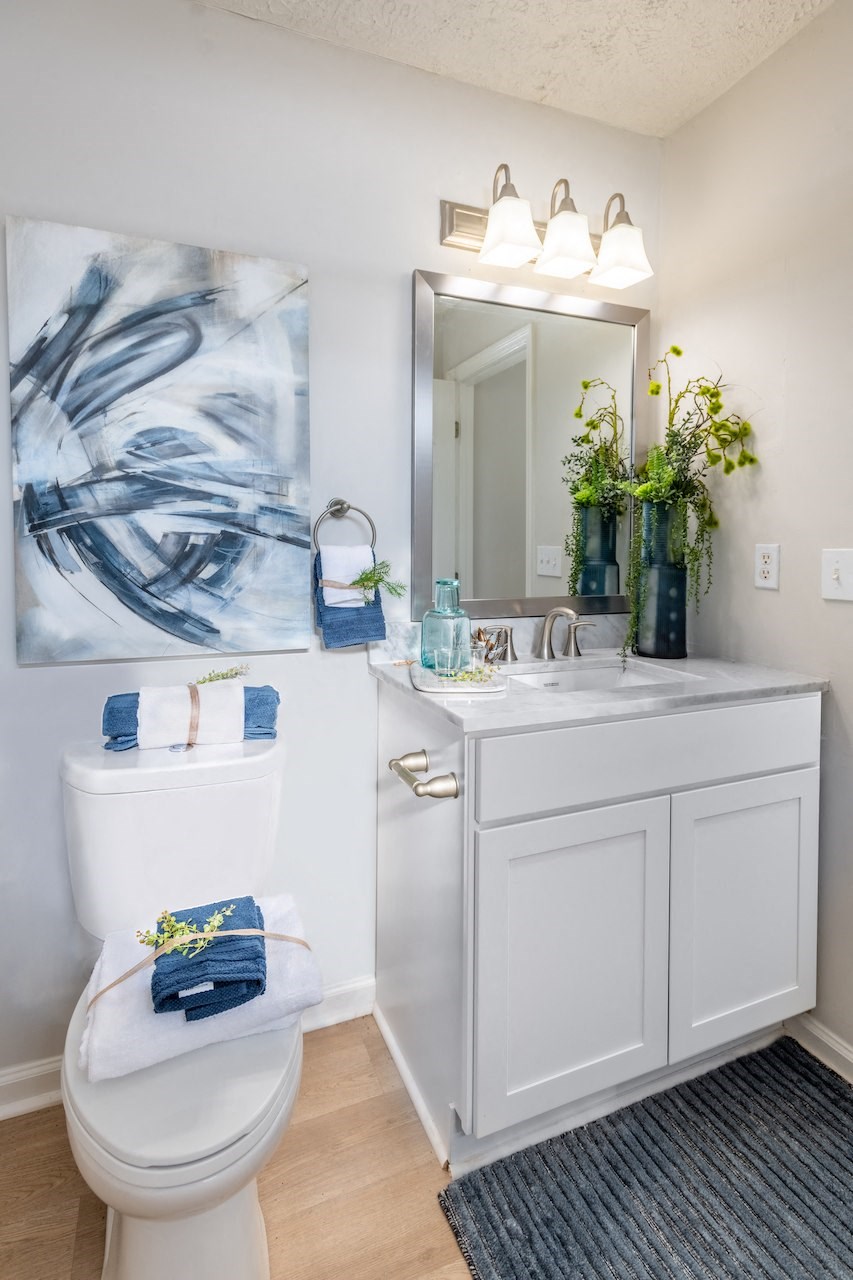 a bathroom with a toilet and a sink and a mirror